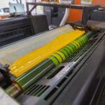 Offset printing machines. Large printing machine perspective. printing machine cylinders and printing ink pot. Offset machine. Offset press is a printing machine designed to produce fine quality