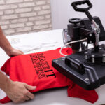 Man,Printing,On,T,Shirt,In,Workshop